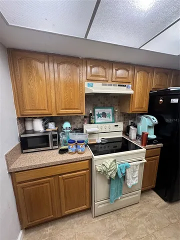 a kitchen with sink cabinets and window