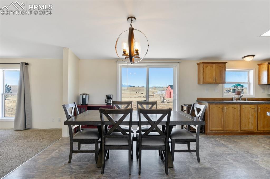 18830 Kevin's View Peyton, CO 80831 - Photo 11 of 37 This home has a wealth of natural light and features a large dining area with a walk out.