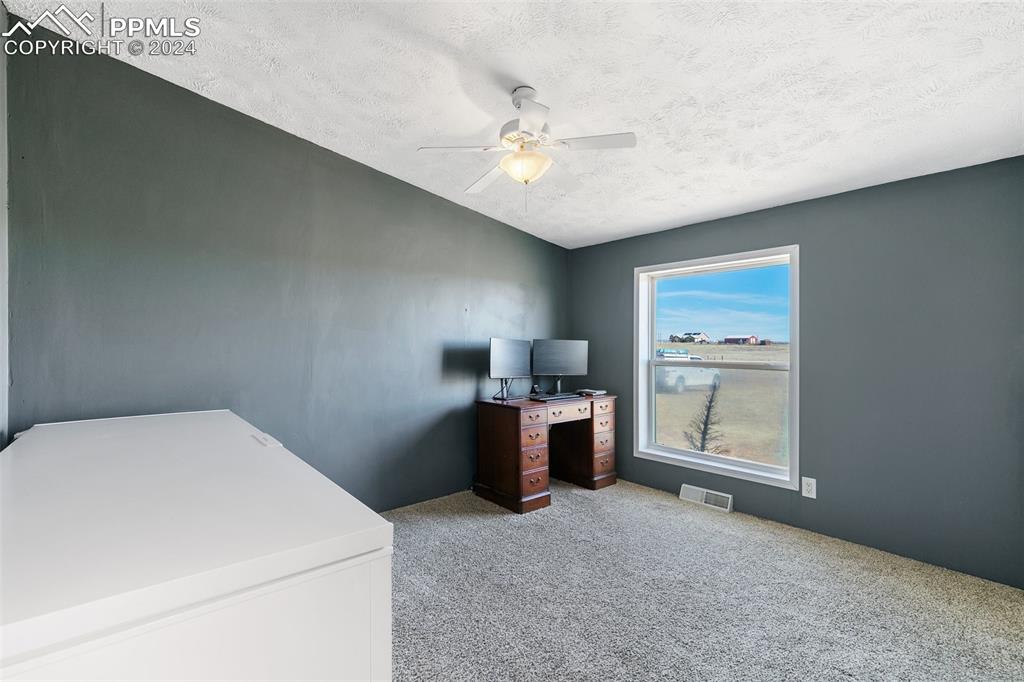 18830 Kevin's View Peyton, CO 80831 - Photo 29 of 37 3 of 3 nice sized bedrooms on the south end of the home - big enough for this huge chest freezer!