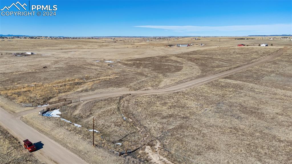 18830 Kevin's View Peyton, CO 80831 - Photo 33 of 37 Aerial view from the NW corner of the property showing the driveway entrance and separately fenced lower pasture.