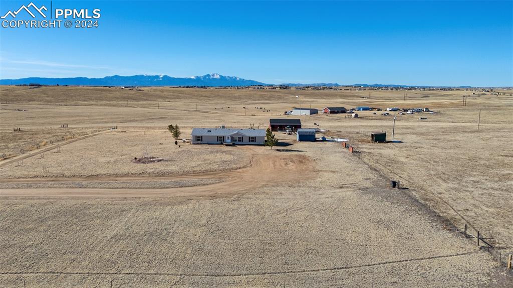 18830 Kevin's View Peyton, CO 80831 - Photo 6 of 37 Aerial view of property showing the mountain range and rural surroundings.