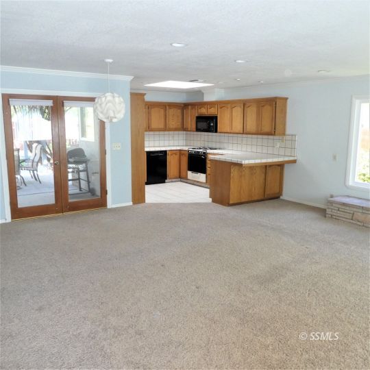1104 North Inyo Street Ridgecrest, CA 93555 - Photo 7 of 31 a large kitchen with a large window and a fireplace