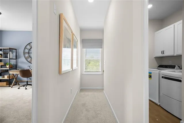 a living room with furniture a rug and a window