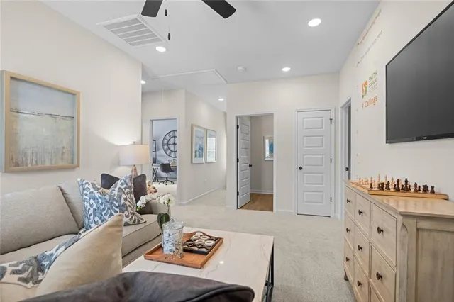 a living room with furniture a large window and a flat screen tv