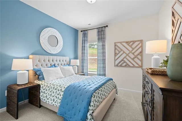 a bedroom with a bed and a dresser in it