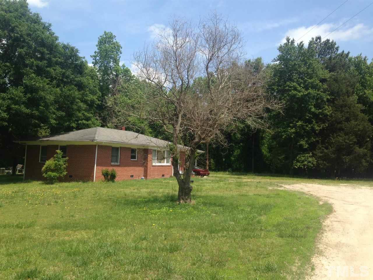 2124 Lizard Lick Road Zebulon, NC 27597 - Photo 5 of 9 a front view of a house with a yard