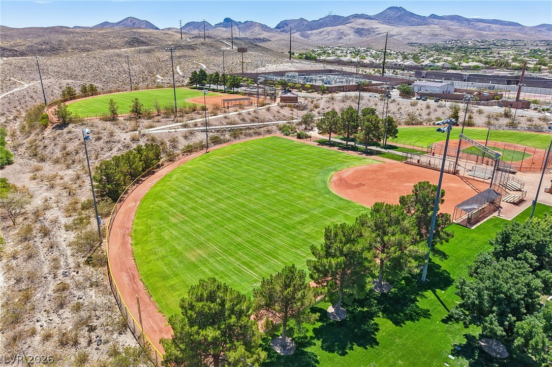 1176 Butternut Ranch Court Henderson, NV 89052 - Photo 59 of 60 An aerial perspective reveals well-maintained sports fields nestled against a desert mountain backdrop.