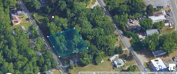 an aerial view of a residential houses with outdoor space and trees