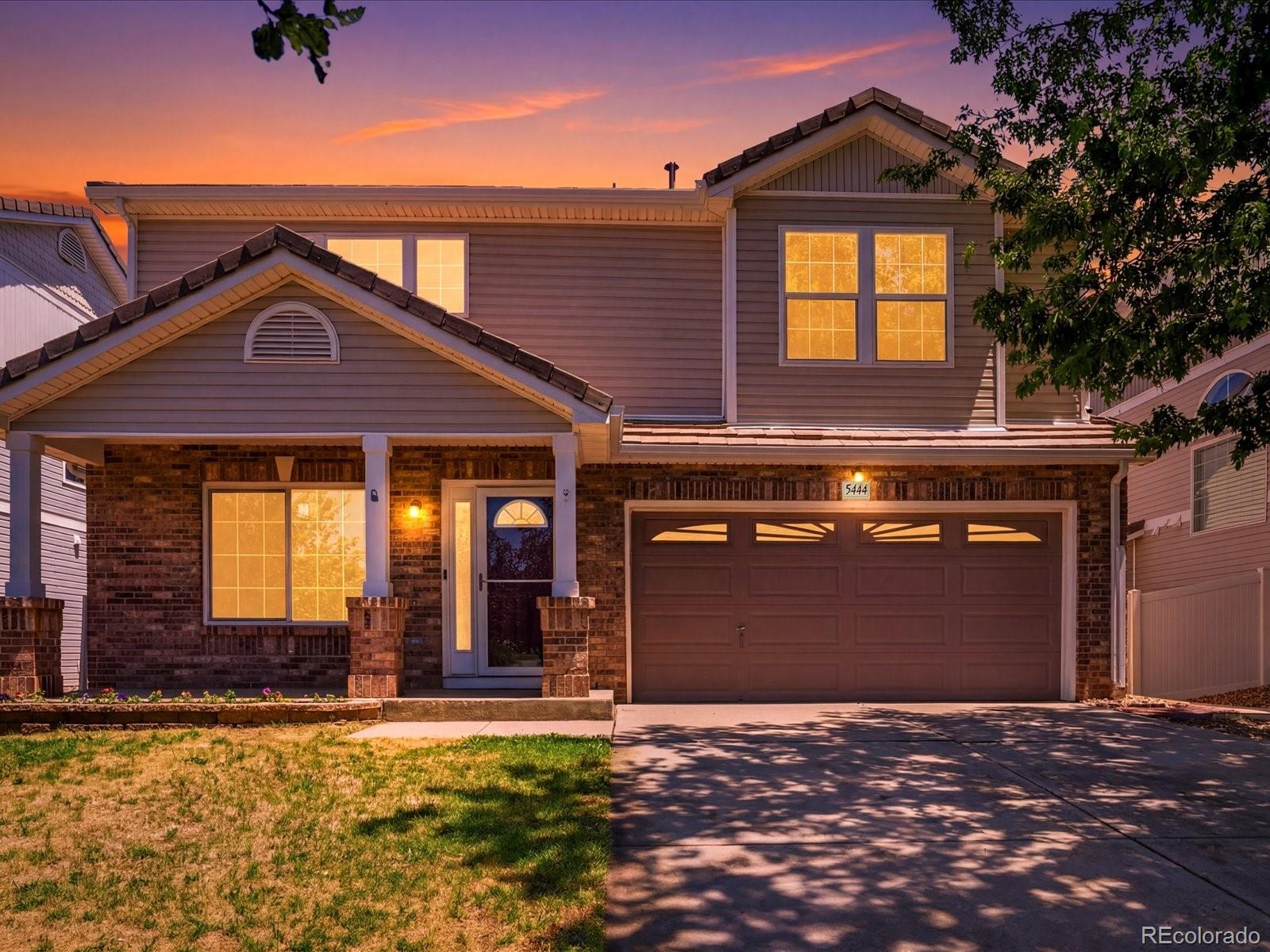 5444 Perth Court Denver, CO 80249 - Photo 1 of 46 a front view of a house with garden