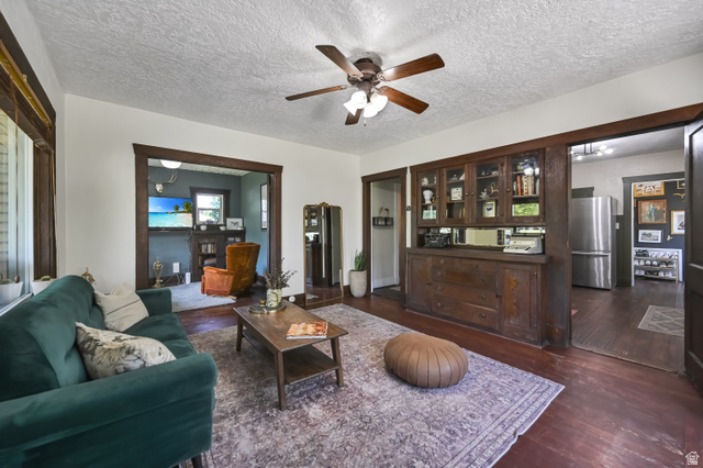 331 West 300 North Logan, UT 84321 - Photo 2 of 28 Living area featuring wood-finish flooring, a ceiling fan with integrated lighting, and white walls