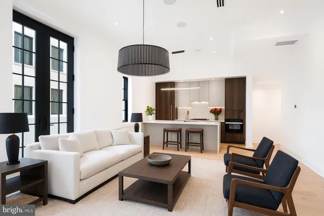 a living room with furniture and a chandelier