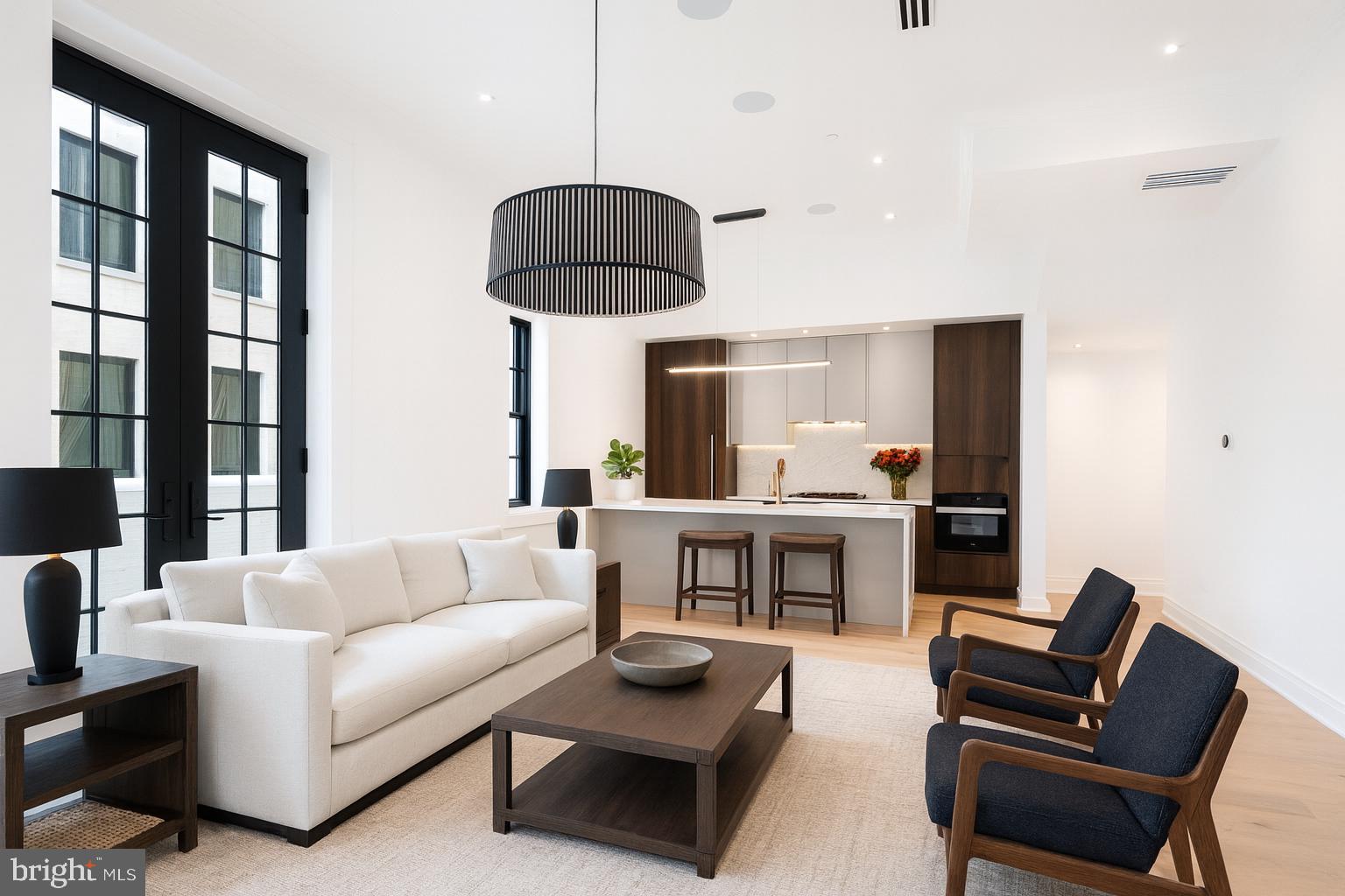 a living room with furniture and a chandelier