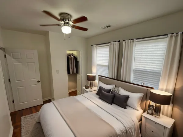 a bedroom with a large bed and a window