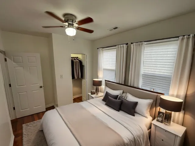 a bedroom with a large bed and a window