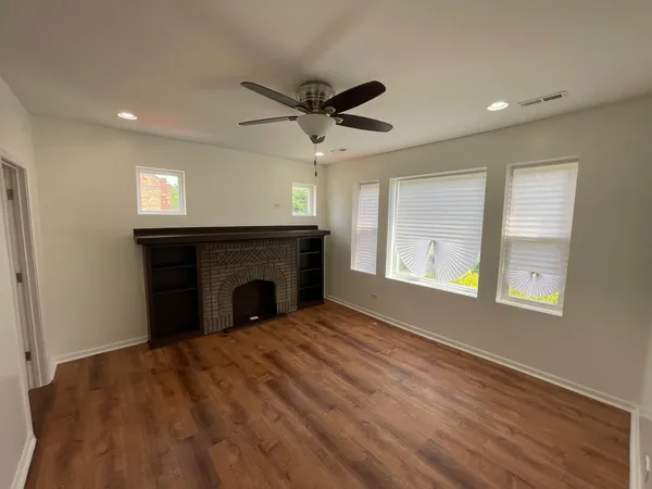a big room with windows and a fireplace