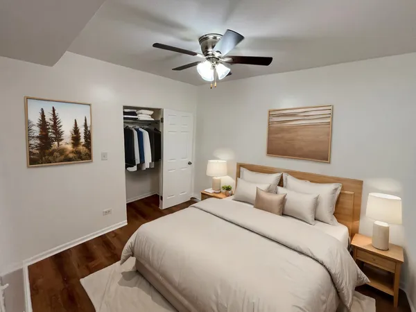 a bedroom with a large bed and a chandelier