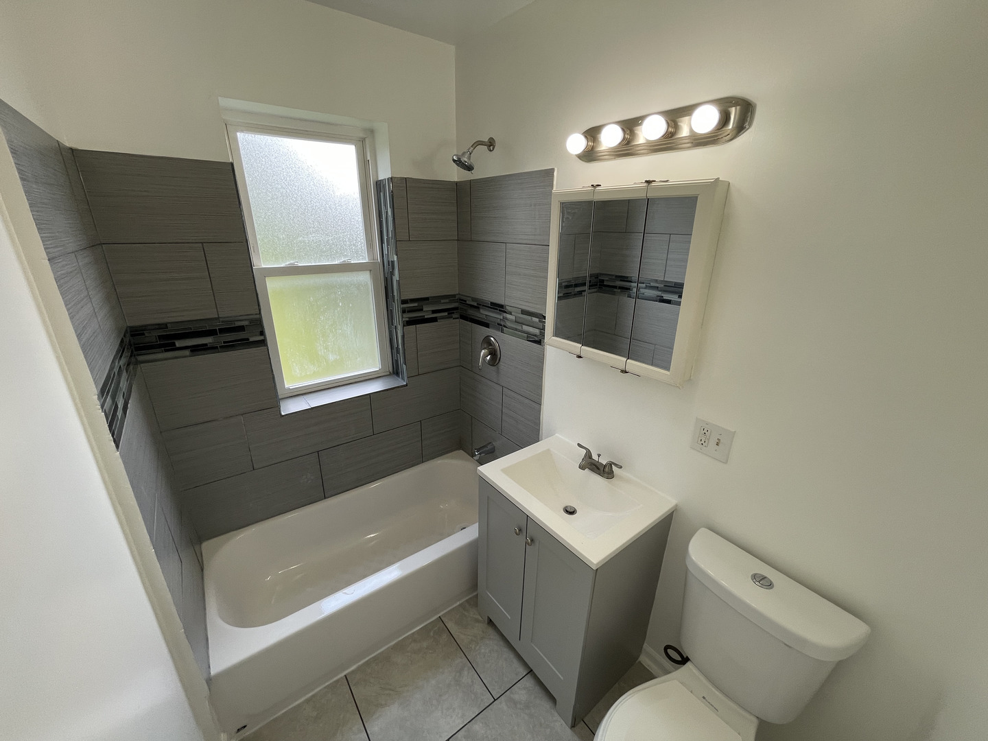1320 West 57th Street, Unit 2 Chicago, IL 60636 - Photo 18 of 18 a bathroom with a sink a toilet and shower