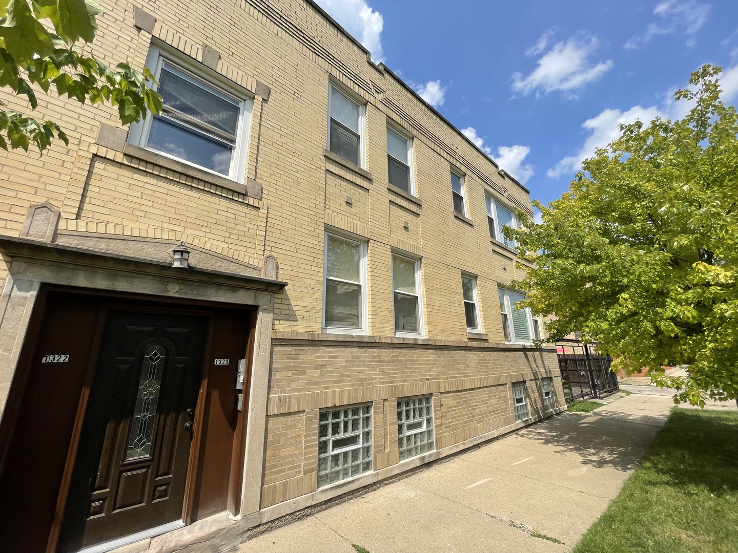 1320 West 57th Street, Unit 2 Chicago, IL 60636 - Photo 2 of 18 a front view of a house with a yard