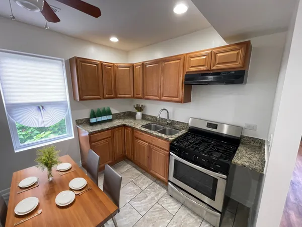 a kitchen with a stove a sink and a microwave