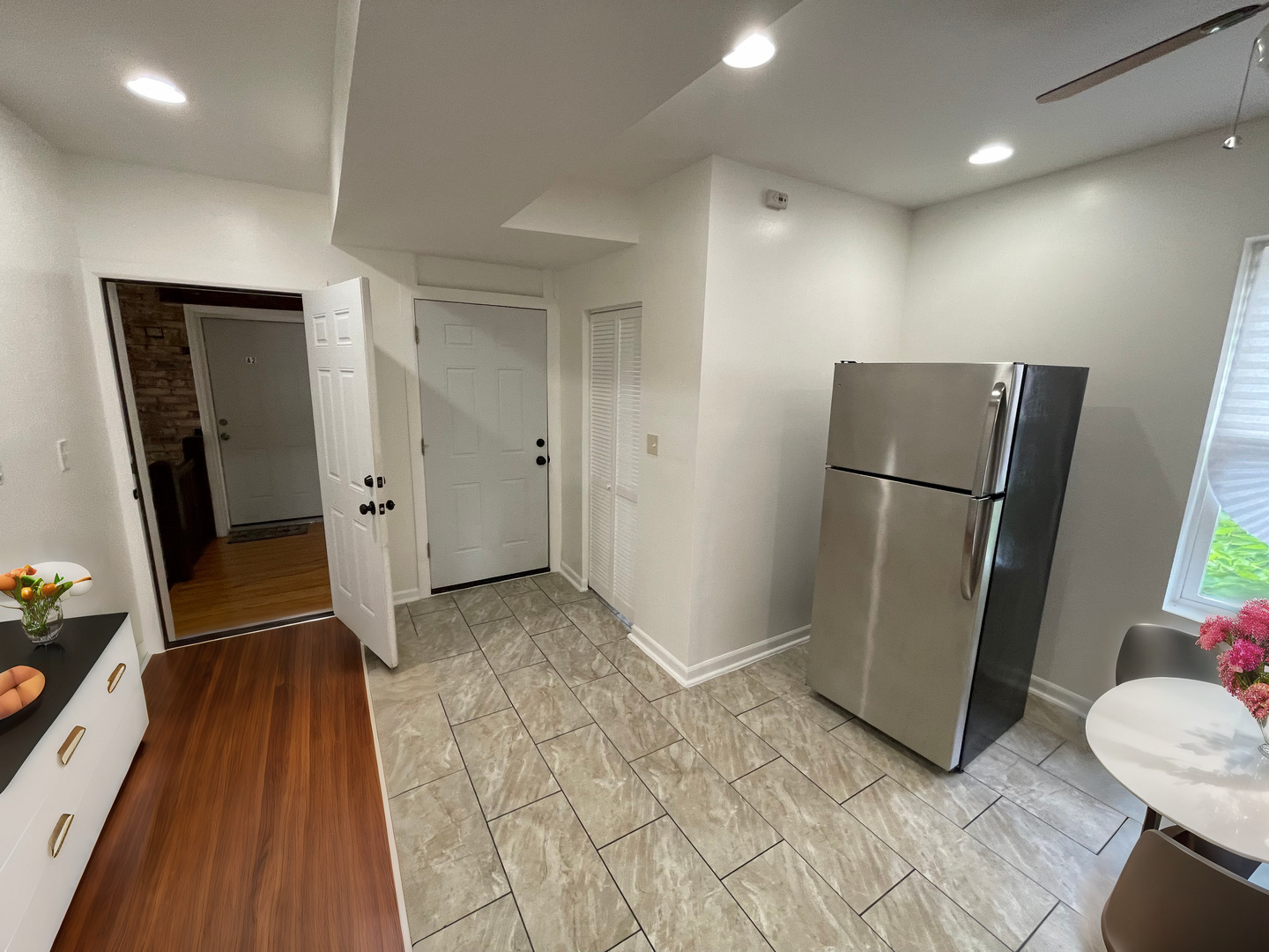 1320 West 57th Street, Unit 2 Chicago, IL 60636 - Photo 5 of 18 a view of a refrigerator in kitchen and an empty room