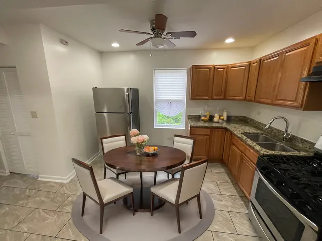 a kitchen with a dining table and chairs