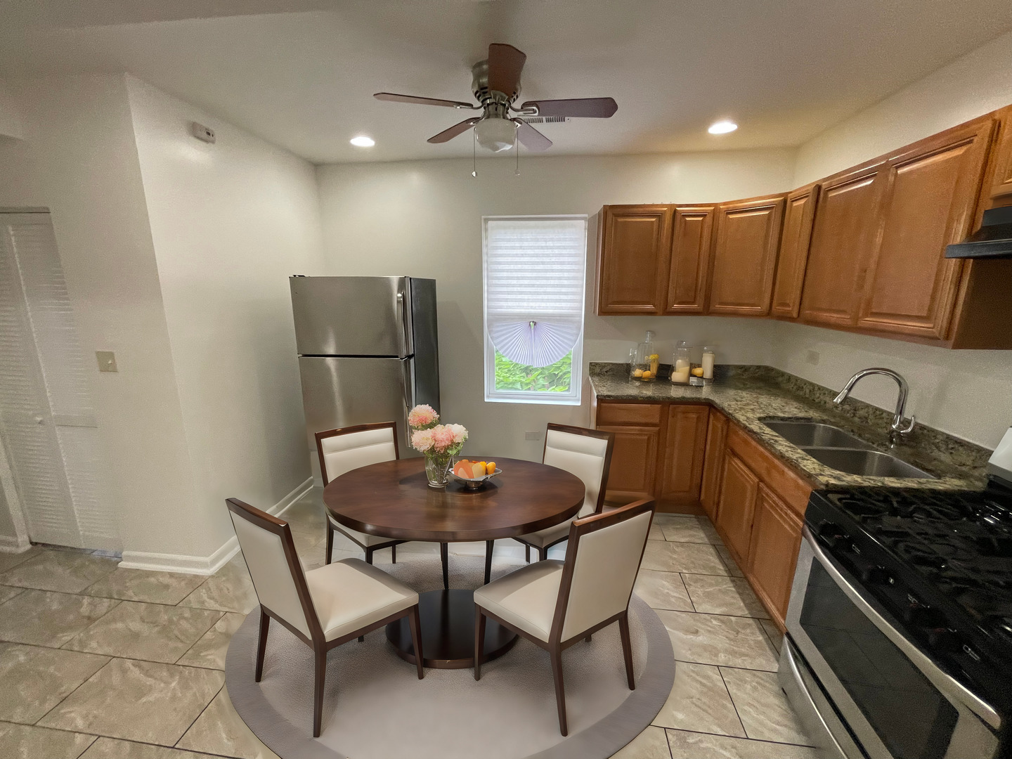 1320 West 57th Street, Unit 2 Chicago, IL 60636 - Photo 7 of 18 a kitchen with a dining table and chairs