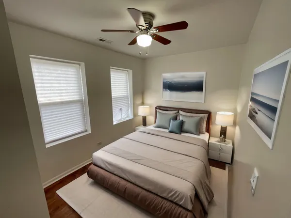 a bedroom with a bed and a ceiling fan