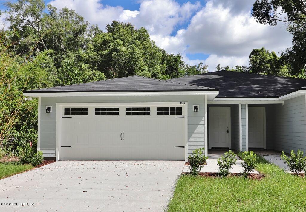 6135 Lone Star Road Jacksonville, FL 32211 - Photo 1 of 2 front view of a house with a yard