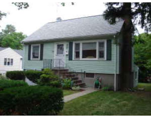 47 Stone Road Arlington, MA 02474 - Photo 1 of 10 a view of a brick house with a yard potted plants and a table
