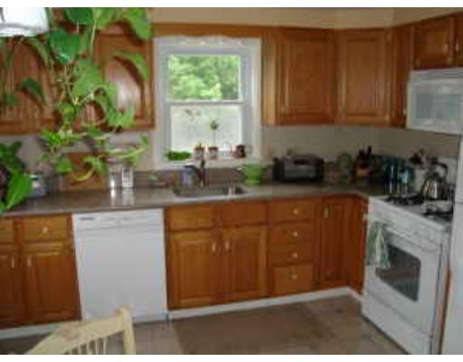 47 Stone Road Arlington, MA 02474 - Photo 3 of 10 a kitchen with stainless steel appliances granite countertop a stove a sink and a microwave