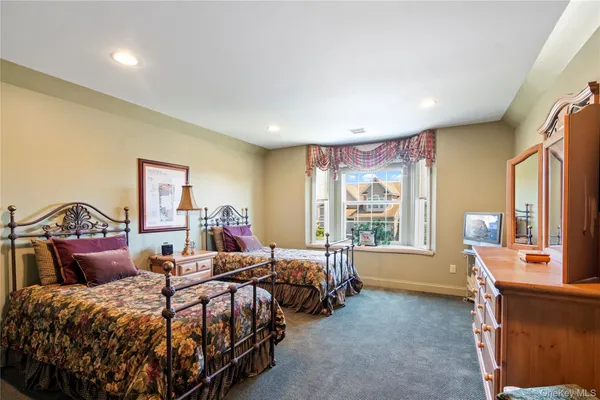 a bed room with two beds and a large window