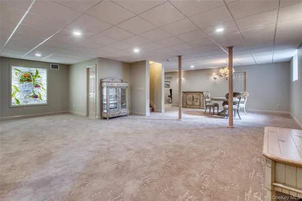 an empty room with furniture and a large mirror