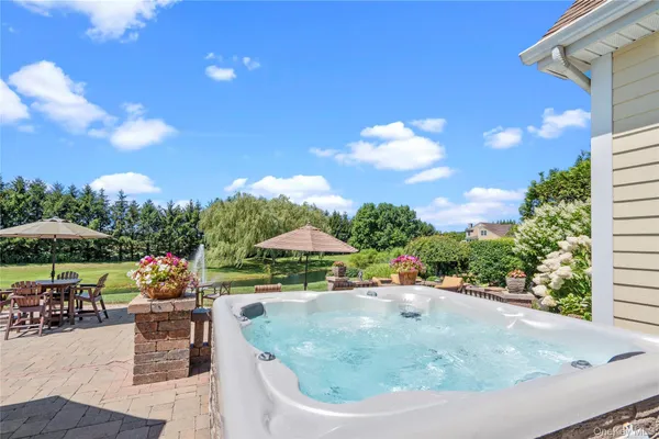 a view of a swimming pool with a patio and a fire pit