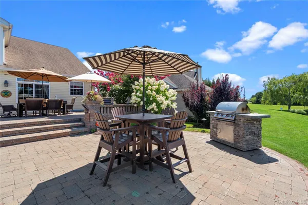 a view of a patio with table and chairs and a yard