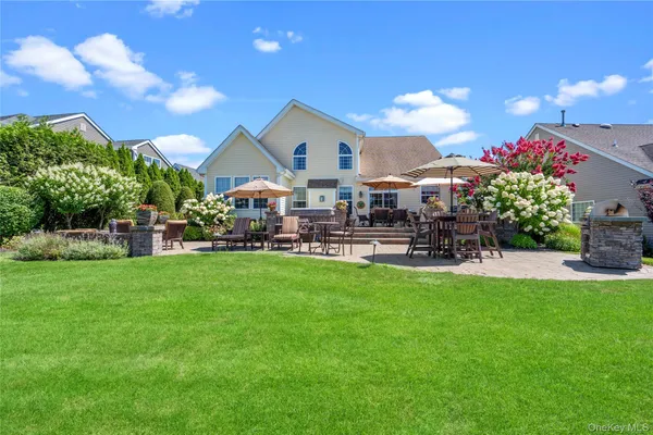 a front view of a house with a garden and sitting area