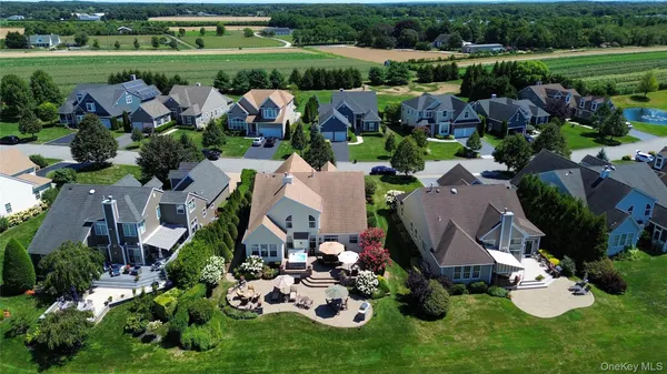 an aerial view of a house with garden space and lake view