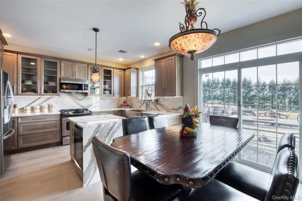 a dining room with furniture a chandelier and window