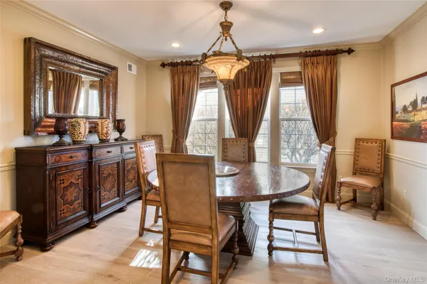 a dining room with a table chairs and a wooden floor