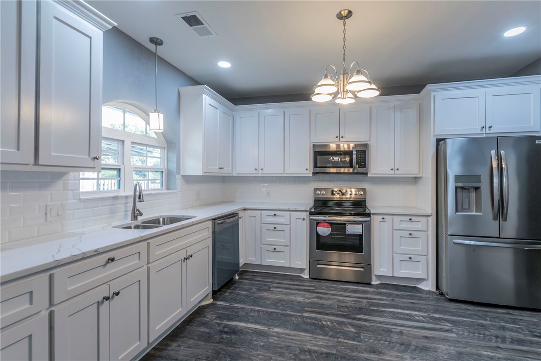 1007 North 22nd Street Waco, TX 76707 - Photo 16 of 26 a kitchen with kitchen island granite countertop stainless steel appliances a stove and a refrigerator