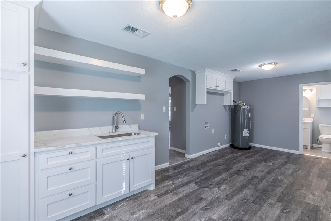 1007 North 22nd Street Waco, TX 76707 - Photo 2 of 26 a spacious bathroom with a granite countertop sink and a mirror