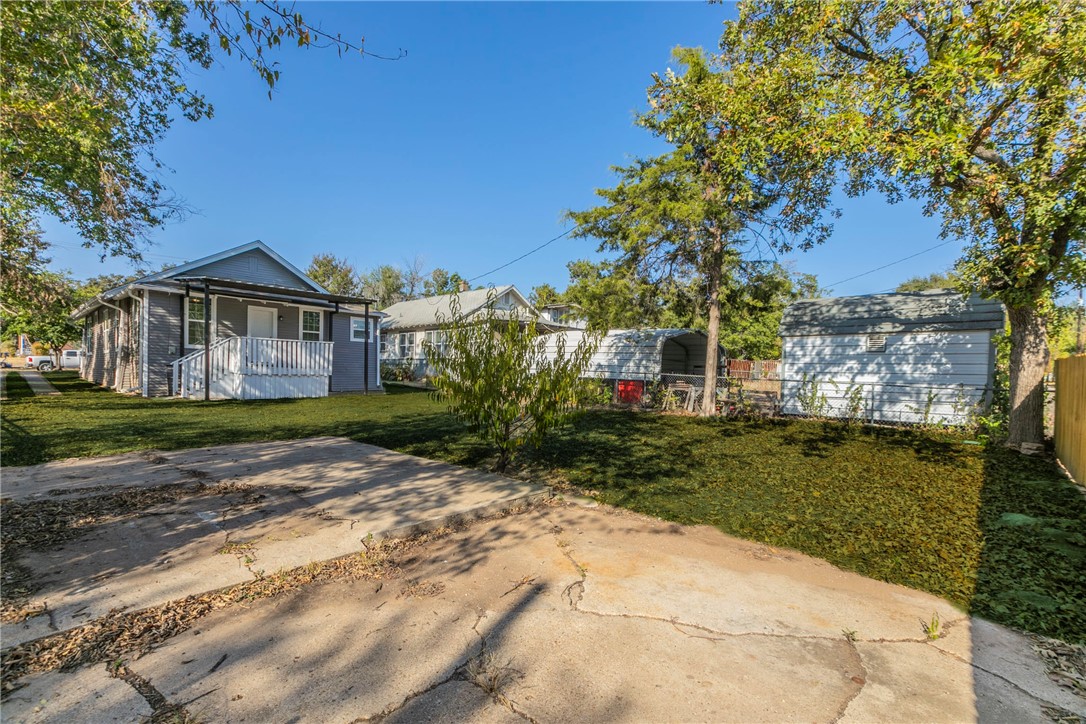 1007 North 22nd Street Waco, TX 76707 - Photo 24 of 26 a view of a big house with a big yard and potted plants and large trees