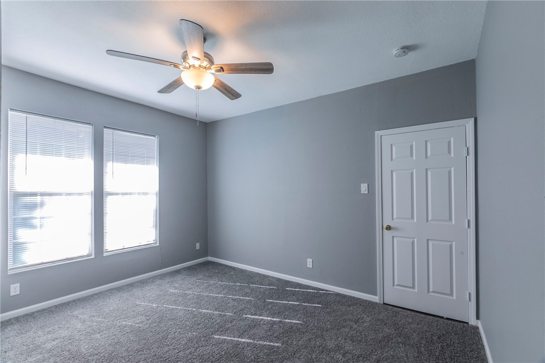 1007 North 22nd Street Waco, TX 76707 - Photo 7 of 26 an empty room with windows and fan