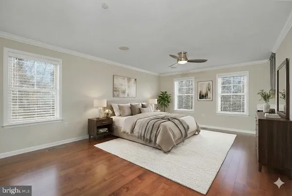 a bedroom with a large bed and a flat tv screen on a dresser