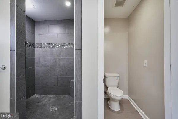 a bathroom with a toilet and a shower