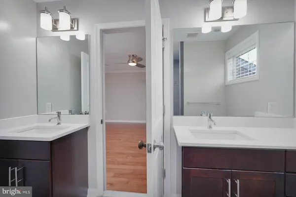 a bathroom with a sink vanity and a mirror