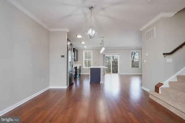 a view of a room with wooden floor and windows