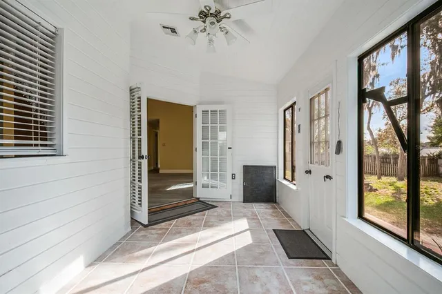 a view of a hallway with a window and outdoor space