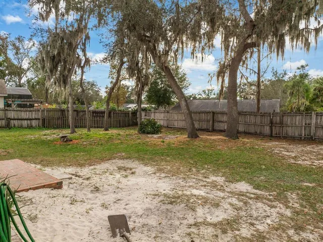 a view of a backyard with large trees