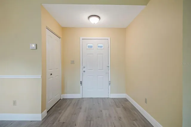 a view of an empty room with wooden floor