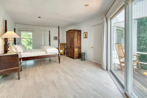 a bedroom with furniture and a window